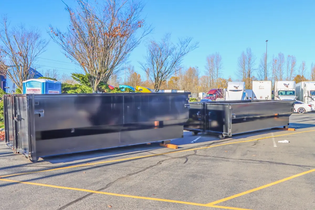 Professional dumpster rental service with roll-off container on residential driveway in Volo